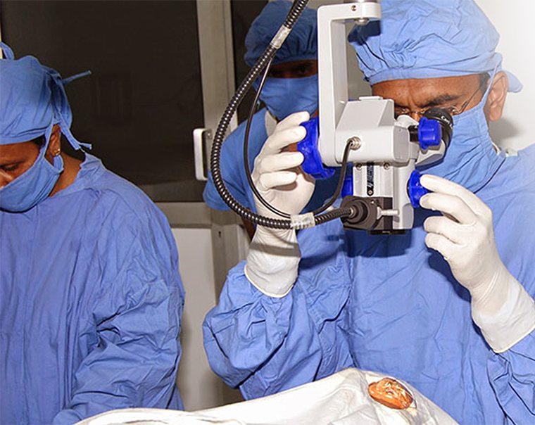 The surgeon at the microscope during a procedure.